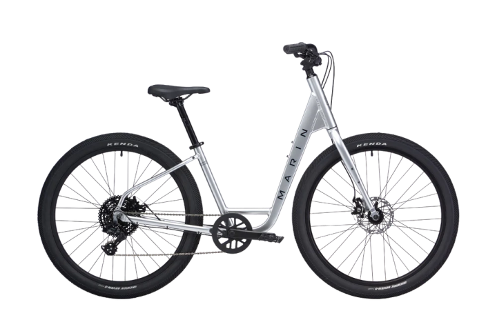Silver step-through bicycle with black tires and seat.