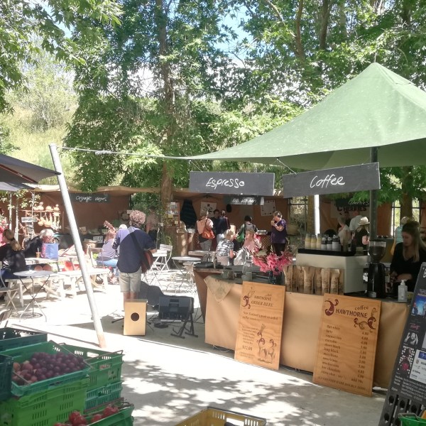 a group of people sitting at a table with an umbrella