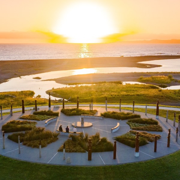 a group of people on a beach near a body of water