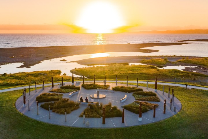 a group of people on a beach near a body of water