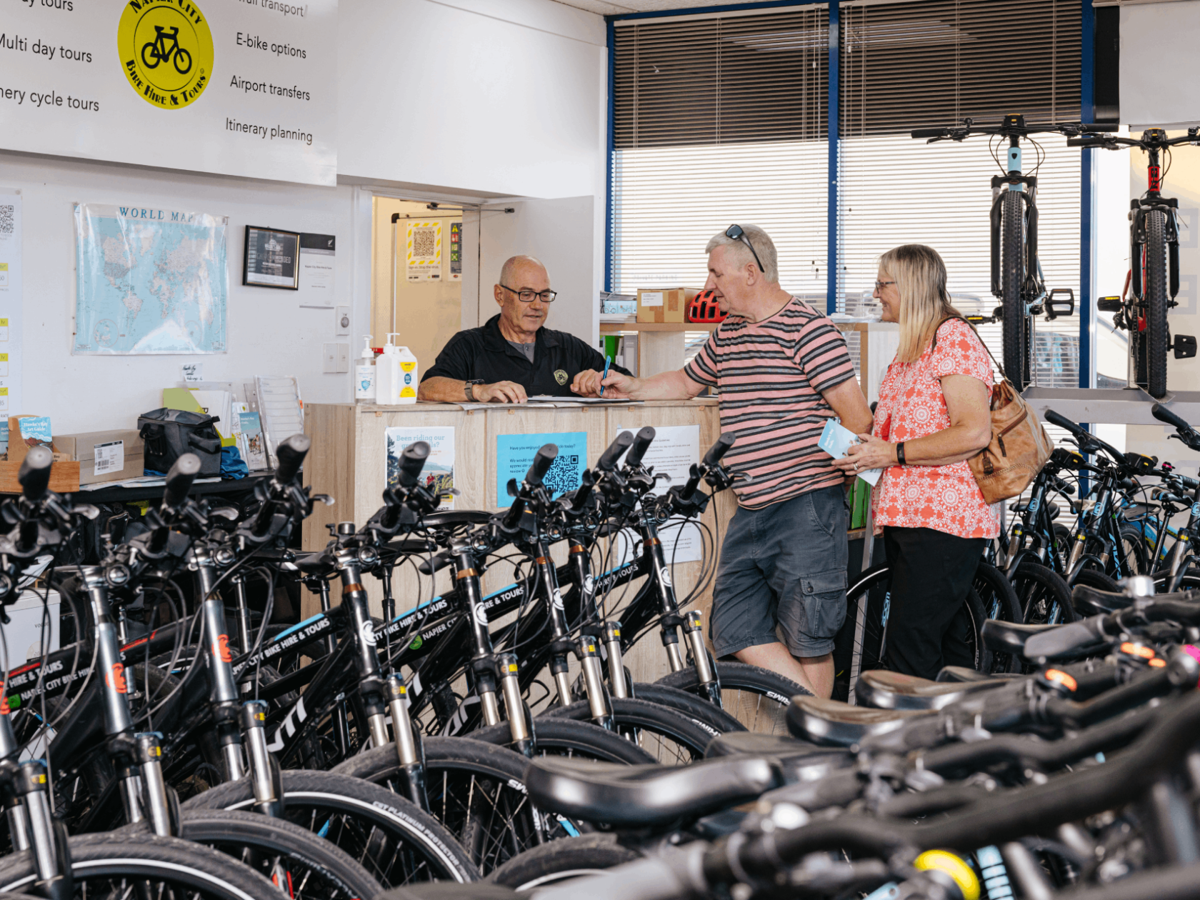a group of people standing in front of a bicycle
