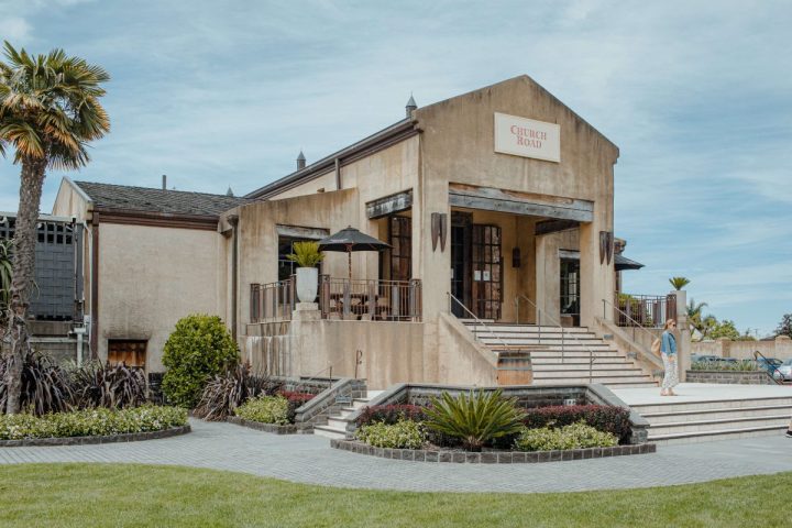 Visitor on the steps at Church Road Winery - a tasting stop with Napier City Bike Hire